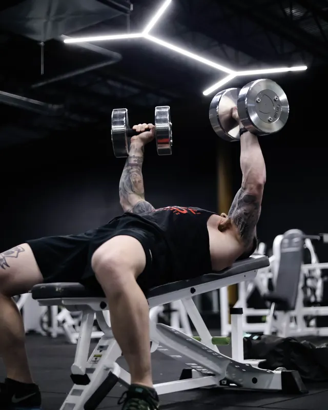 Dumbbell press under the lights